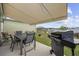 Covered patio featuring outdoor dining set, grill, retractable awning, and scenic pond view at 362 Shallow Cove Dr., Conway, SC 29527