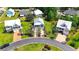 An aerial view of neighborhood homes with lush landscaping, palm trees, and access to a nearby pond at 374 Graytwig Circle, Murrells Inlet, SC 29576