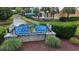 Community welcome sign for Abaco Cove in front of lovely canal and attractive landscaping at 374 Graytwig Circle, Murrells Inlet, SC 29576