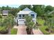 Charming two-story beach home with a metal roof, brick driveway, and lovely landscaping at 374 Graytwig Circle, Murrells Inlet, SC 29576