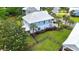 Backyard view of a two-story beach home with green lawn, and a metal roof at 374 Graytwig Circle, Murrells Inlet, SC 29576