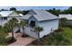 Rear view of a two-story beach home with metal roof, garage, and brick driveway at 374 Graytwig Circle, Murrells Inlet, SC 29576