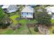 Aerial backyard view of a two-story beach house with screened in porch and beautiful landscaping at 374 Graytwig Circle, Murrells Inlet, SC 29576