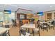 A bar area featuring wood finishes, bar stools, multiple tables and chairs, and two TVs at 415 Ocean Creek Dr. # 2245, Myrtle Beach, SC 29572