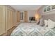 Bedroom with a queen-sized bed, closet, TV, and beach-themed decor at 415 Ocean Creek Dr. # 2245, Myrtle Beach, SC 29572