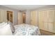 Bedroom showcases two closets, neutral walls, laminate flooring, and coastal-themed bedding at 415 Ocean Creek Dr. # 2245, Myrtle Beach, SC 29572