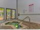 A cozy, tiled hot tub next to a sliding glass door and surrounded by a brick paver floor at 415 Ocean Creek Dr. # 2245, Myrtle Beach, SC 29572