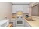 Well-lit kitchen featuring white appliances, ample cabinet space, and laminate countertops at 415 Ocean Creek Dr. # 2245, Myrtle Beach, SC 29572