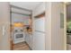 Bright kitchen includes a white refrigerator, range, microwave, and wood-look laminate flooring at 415 Ocean Creek Dr. # 2245, Myrtle Beach, SC 29572