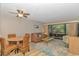 Living room features a dining table, ceiling fan, and sliding glass doors leading to the porch at 415 Ocean Creek Dr. # 2245, Myrtle Beach, SC 29572