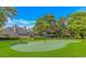 Lush putting green surrounded by green grass and well-maintained landscaping and townhome buildings at 415 Ocean Creek Dr. # 2245, Myrtle Beach, SC 29572