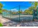 View of a tennis court with a green fence and townhome buildings in the background at 415 Ocean Creek Dr. # 2245, Myrtle Beach, SC 29572