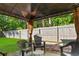 Enjoy the backyard complete with a gazebo and hardscaped seating area at 4171 Wrens Crossing, Little River, SC 29566
