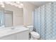 Bright bathroom featuring a vanity with sink, toilet, and shower with patterned curtain at 4171 Wrens Crossing, Little River, SC 29566