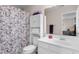 Bathroom features a vanity with storage, toilet, and a shower with patterned curtain at 4171 Wrens Crossing, Little River, SC 29566