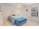 Bedroom includes a full-size bed, end tables, overhead fan, and window with blinds at 4171 Wrens Crossing, Little River, SC 29566