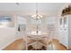 Dining room features a round table, neutral chairs, chandelier and natural light at 4171 Wrens Crossing, Little River, SC 29566