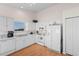 Bright kitchen with white cabinetry, appliances, and laminate floors, perfect for cooking at 4171 Wrens Crossing, Little River, SC 29566