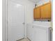 This laundry room comes equipped with a washer, dryer, and cabinet storage at 4171 Wrens Crossing, Little River, SC 29566