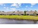 Back view of townhomes with well-manicured lawns that extend down to the tranquil waters of the lake at 4359 Livorn Loop # 4359, Myrtle Beach, SC 29579