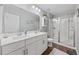 Bright bathroom with double sinks, a walk-in shower, and wood-look floors at 4359 Livorn Loop # 4359, Myrtle Beach, SC 29579