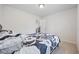 A minimalistic bedroom with neutral walls and carpet, featuring a bed and view into the kitchen at 4359 Livorn Loop # 4359, Myrtle Beach, SC 29579