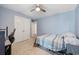 Blue bedroom featuring carpeted floors, a ceiling fan, and closet doors at 4359 Livorn Loop # 4359, Myrtle Beach, SC 29579