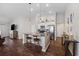 Bright kitchen featuring an island with seating, granite counters and hardwood floors at 4359 Livorn Loop # 4359, Myrtle Beach, SC 29579