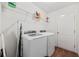 Bright laundry room with modern washer and dryer, shelving, and a door at 4359 Livorn Loop # 4359, Myrtle Beach, SC 29579