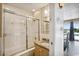 This renovated bathroom provides a shower and bath, a granite countertop vanity, and views of the backyard pool at 4501 S Ocean Blvd., North Myrtle Beach, SC 29582