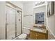 This bright bathroom offers a glass shower, toilet, large mirror, and granite countertop on the vanity at 4501 S Ocean Blvd., North Myrtle Beach, SC 29582