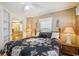 A cozy bedroom with a decorative pineapple theme, two lamps, a window, and an ensuite bathroom at 4501 S Ocean Blvd., North Myrtle Beach, SC 29582