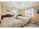 Bedroom featuring two twin beds, wood-look floors, yellow-colored walls and ceiling fan at 4501 S Ocean Blvd., North Myrtle Beach, SC 29582