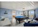 Spacious game room with a pool table, dining table, comfortable chairs, and coastal decor at 4501 S Ocean Blvd., North Myrtle Beach, SC 29582