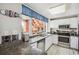Bright kitchen featuring white cabinetry, stainless steel appliances, and granite countertops at 4501 S Ocean Blvd., North Myrtle Beach, SC 29582