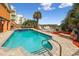 Inviting pool area with blue tiled pool, brick deck, lounge chairs, tropical foliage, and ocean views at 4501 S Ocean Blvd., North Myrtle Beach, SC 29582