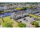 Aerial view of a three-story condo building near waterway, parking and manicured lawn at 4524 N Plantation Harbour Dr. # B3, Little River, SC 29566