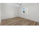 Bright bedroom features wood-look floors, white walls, window, and modern ceiling fan at 4524 N Plantation Harbour Dr. # B3, Little River, SC 29566