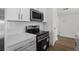 Clean kitchen includes stainless steel range, microwave, and white tile backsplash at 4524 N Plantation Harbour Dr. # B3, Little River, SC 29566