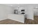 Bright kitchen features stainless appliances, white cabinets, and breakfast bar for easy entertaining at 4524 N Plantation Harbour Dr. # B3, Little River, SC 29566