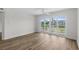 Large living space with modern ceiling fan and balcony access via sliding glass door at 4524 N Plantation Harbour Dr. # B3, Little River, SC 29566
