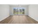 Bright living room with hardwood floors features sliding glass doors to a private balcony at 4524 N Plantation Harbour Dr. # B3, Little River, SC 29566