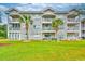The exterior showcases a multi-story condo building, featuring balconies and lush landscaping at 4683 Wild Iris Dr. # 104, Myrtle Beach, SC 29577