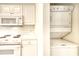 Efficient kitchen with microwave, stove, and washer/dryer combo at 4683 Wild Iris Dr. # 104, Myrtle Beach, SC 29577