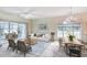 Bright living room featuring a modern sofa, wood coffee table, chandelier, and a sunroom at 4683 Wild Iris Dr. # 104, Myrtle Beach, SC 29577