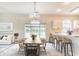 Open-concept living and dining area with modern furnishings, a chandelier, and natural light at 4683 Wild Iris Dr. # 104, Myrtle Beach, SC 29577