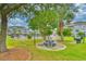Outdoor picnic area with grill and playground surrounded by lush greenery at 4683 Wild Iris Dr. # 104, Myrtle Beach, SC 29577