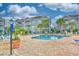 Community pool area with blue lounge chairs, palm trees, and well-maintained landscaping at 4683 Wild Iris Dr. # 104, Myrtle Beach, SC 29577