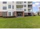 Exterior view of condo showing brick facade, lawn, and sliding glass door at 4812 Magnolia Lake Dr. # 102, Myrtle Beach, SC 29577
