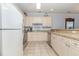 Well-lit kitchen with tiled floors and plenty of cabinet storage space at 4812 Magnolia Lake Dr. # 102, Myrtle Beach, SC 29577
